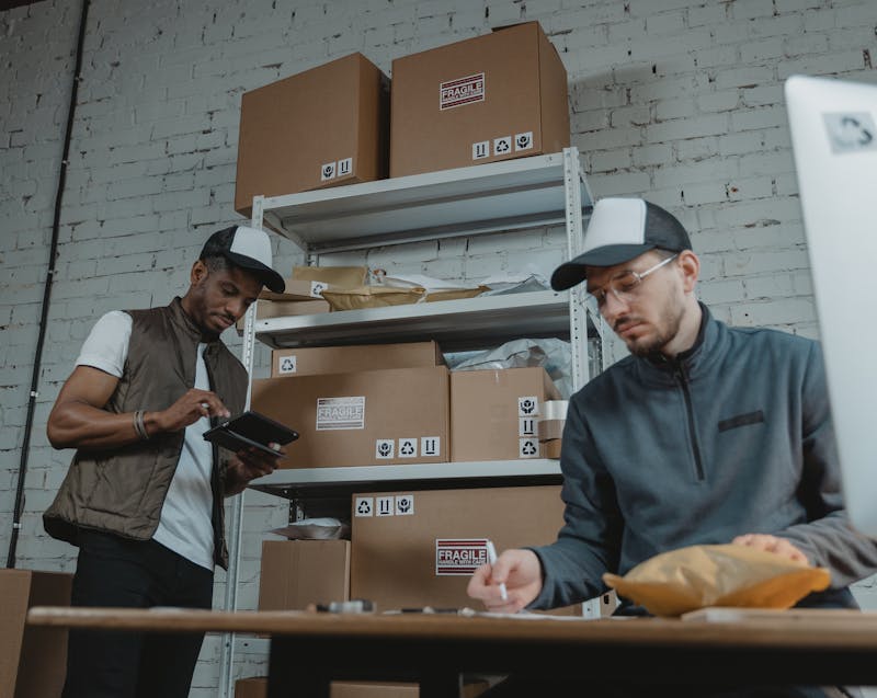 business partners sorting delivered items in boxes